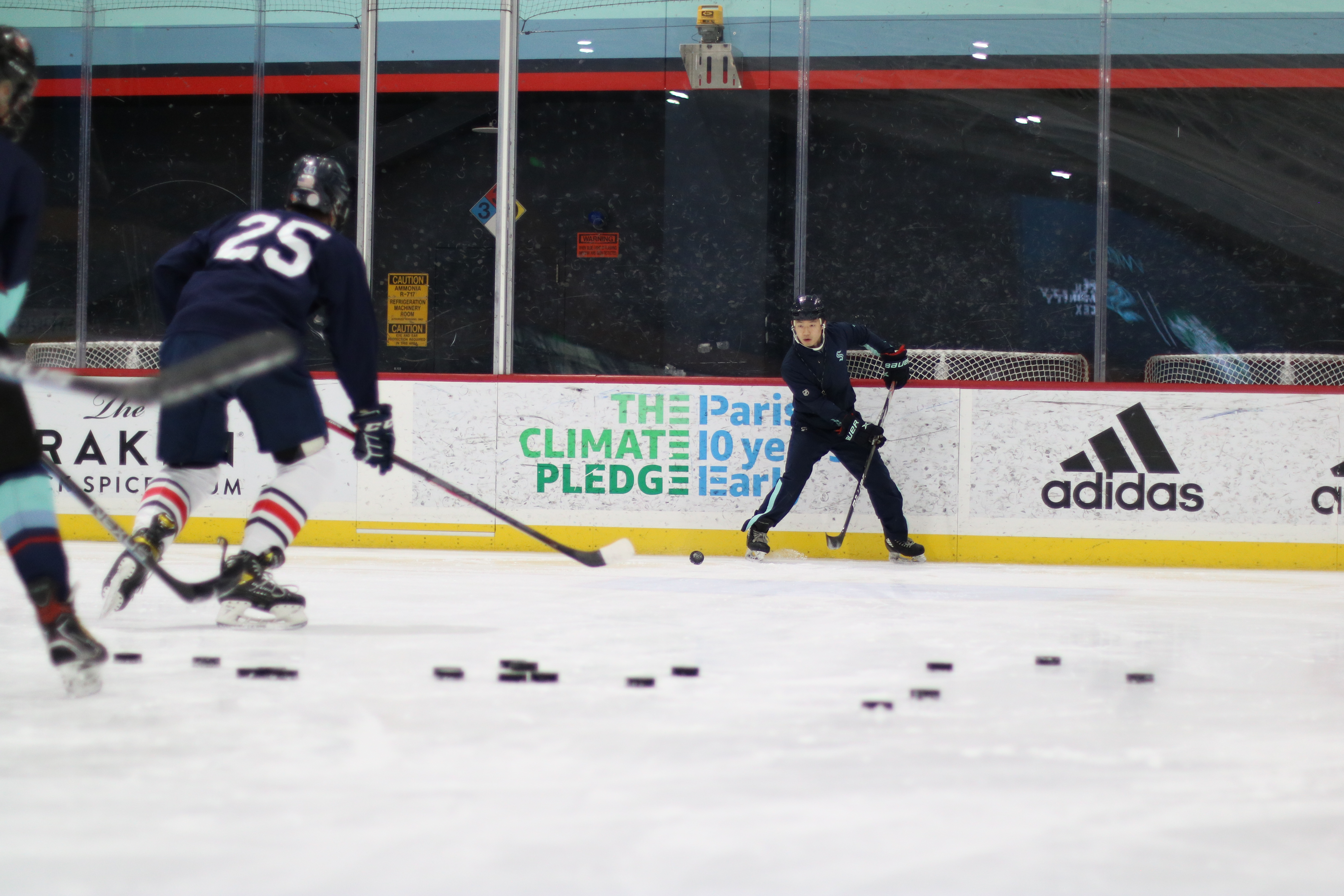 Image of coach running drills with youth hockey player